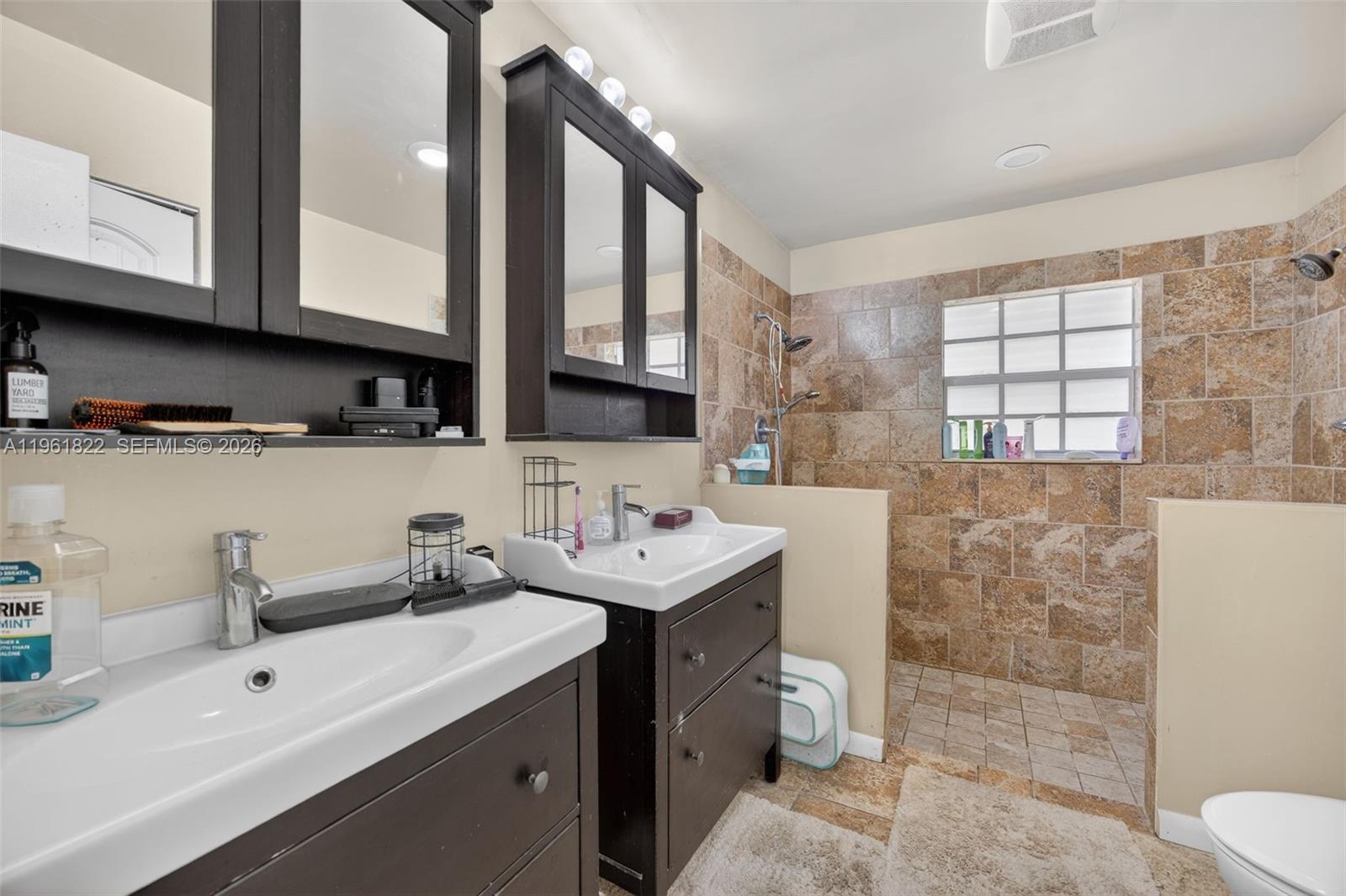 9401 Southwest 97th Avenue Miami, FL 33176 - Photo 52 of 77 a bathroom with a sink toilet a mirror and shower