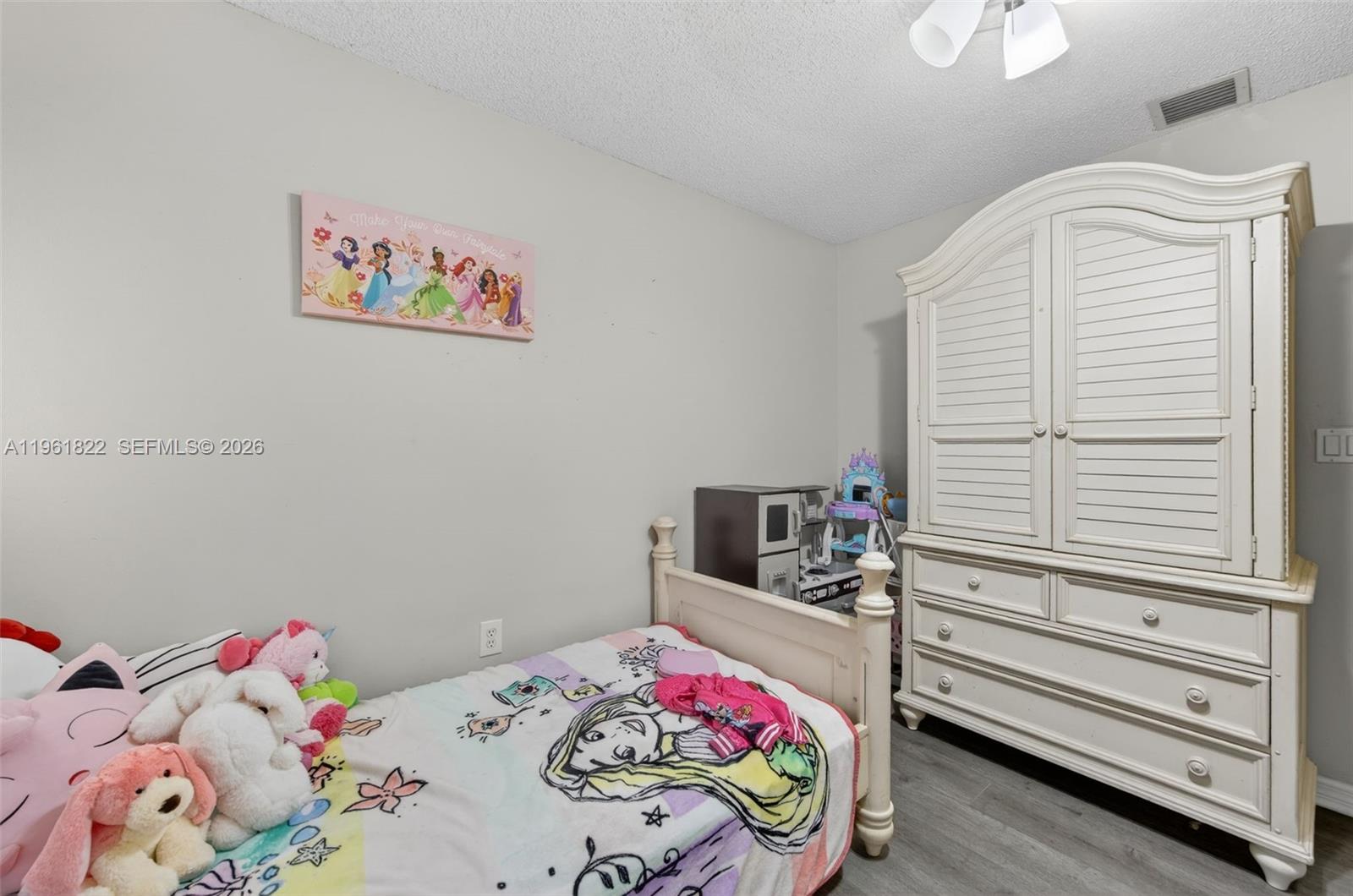 9401 Southwest 97th Avenue Miami, FL 33176 - Photo 55 of 77 a bedroom with a bed and a dresser in it