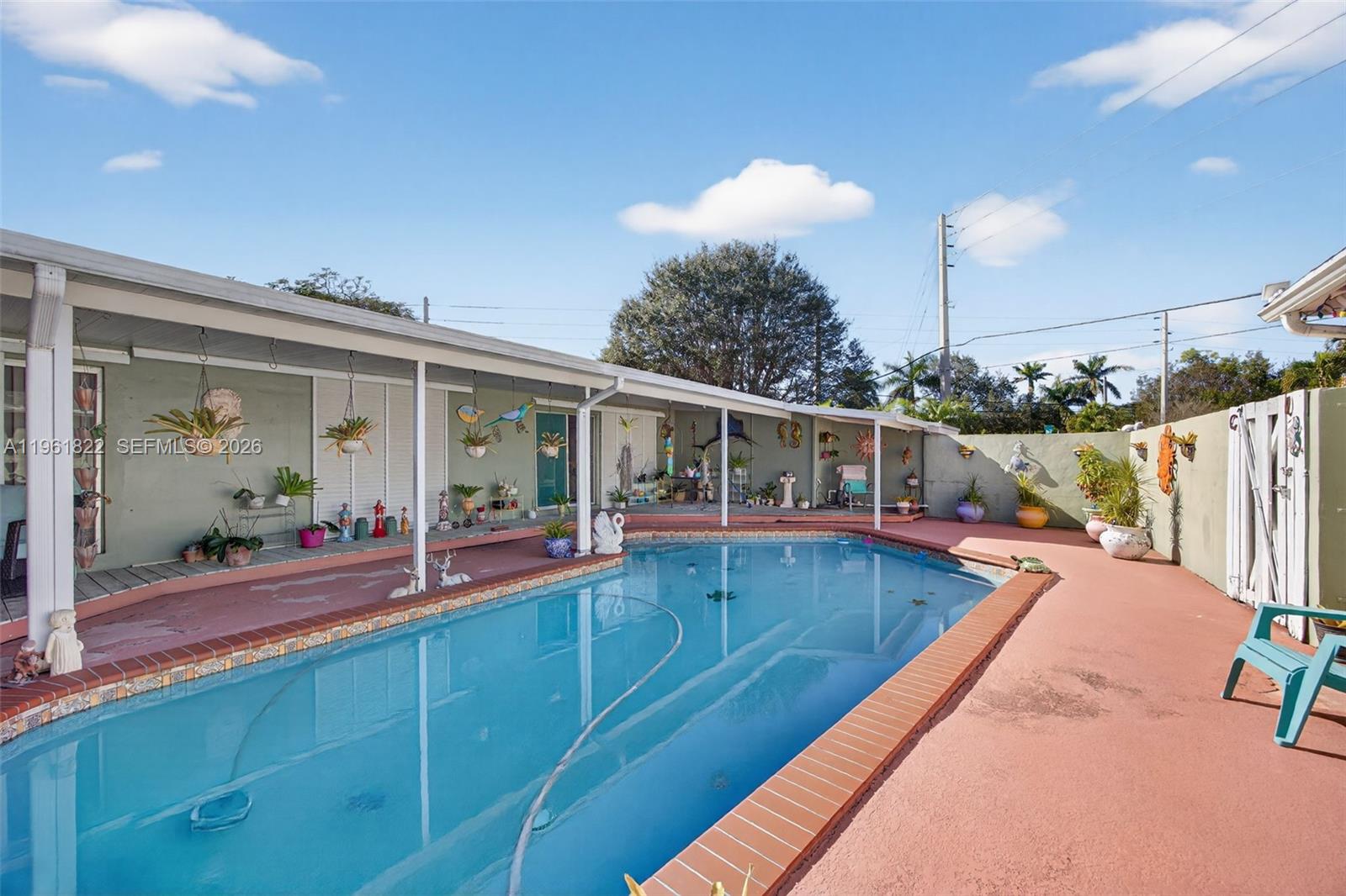 9401 Southwest 97th Avenue Miami, FL 33176 - Photo 59 of 77 a view of a house with swimming pool and porch