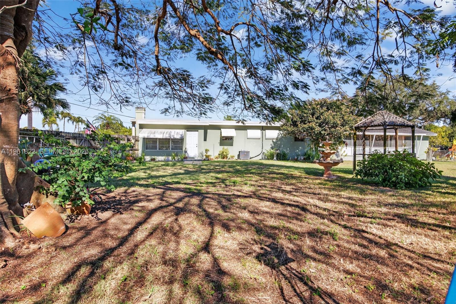 9401 Southwest 97th Avenue Miami, FL 33176 - Photo 73 of 77 a front view of a house with a garden