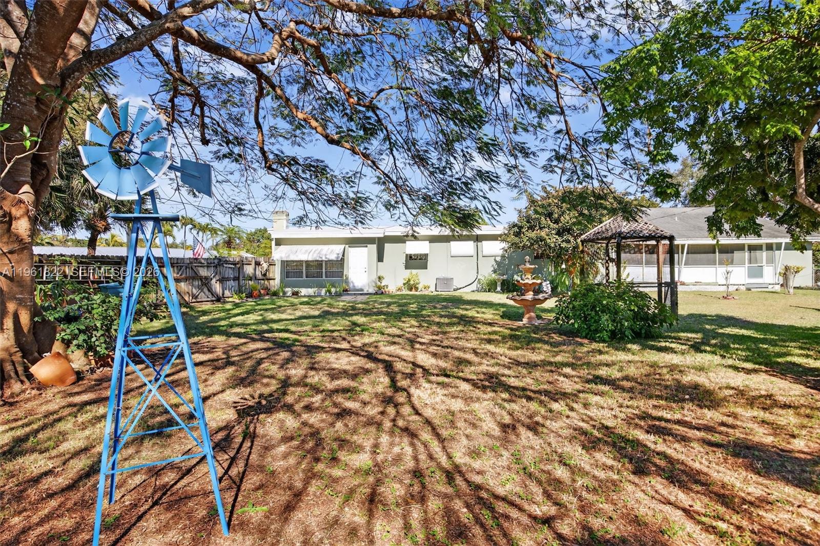 9401 Southwest 97th Avenue Miami, FL 33176 - Photo 74 of 77 a front view of a house with a big yard