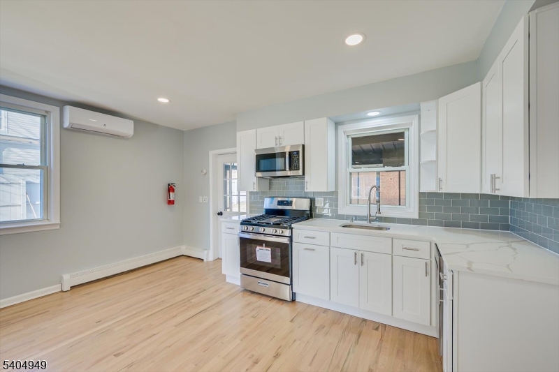 34 Tillman Street Raritan, NJ 08869 - Photo 11 of 31 a kitchen with granite countertop white cabinets and stainless steel appliances