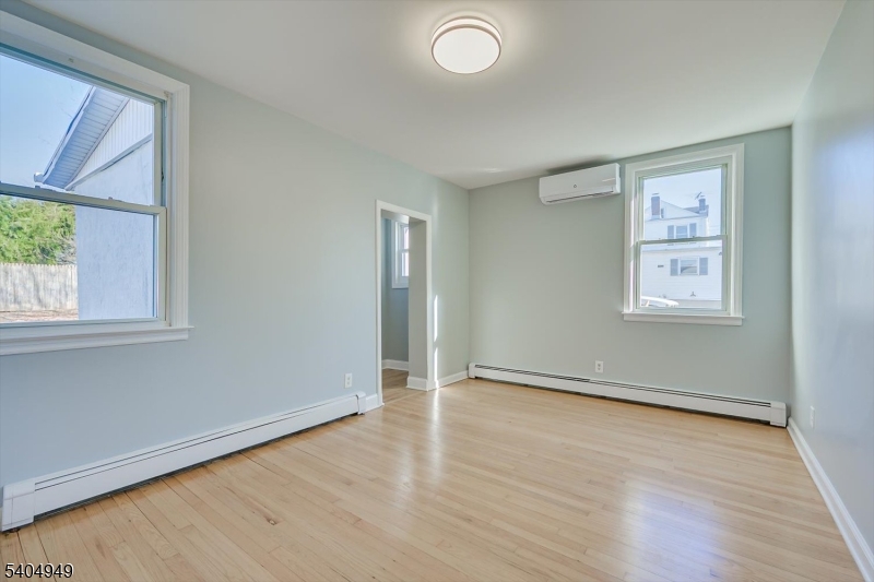 34 Tillman Street Raritan, NJ 08869 - Photo 12 of 31 an empty room with wooden floor and windows