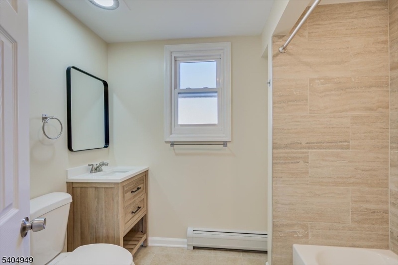 34 Tillman Street Raritan, NJ 08869 - Photo 14 of 31 a bathroom with a granite countertop toilet sink and mirror