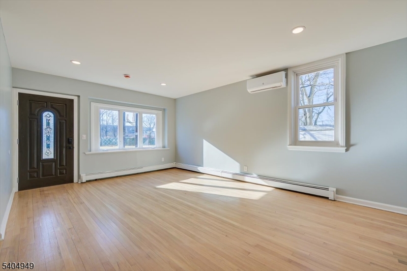 34 Tillman Street Raritan, NJ 08869 - Photo 6 of 31 a view of an empty room with a window and wooden floor