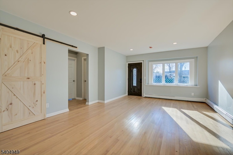 34 Tillman Street Raritan, NJ 08869 - Photo 7 of 31 wooden floor in an empty room with a window