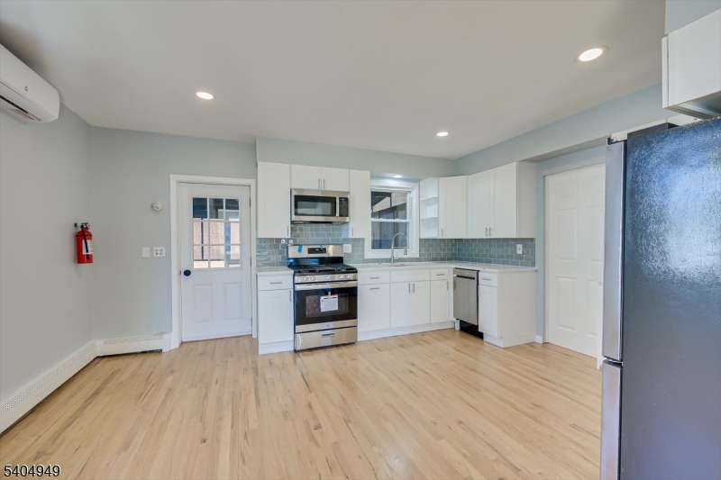 34 Tillman Street Raritan, NJ 08869 - Photo 8 of 31 a kitchen with granite countertop white cabinets and stainless steel appliances