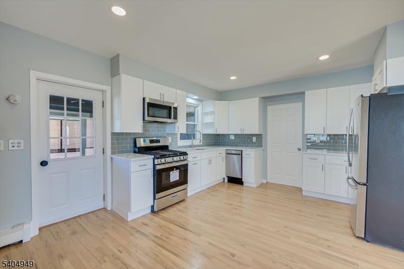 34 Tillman Street Raritan, NJ 08869 - Photo 9 of 31 a kitchen with white cabinets and stainless steel appliances