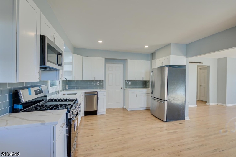 34 Tillman Street Raritan, NJ 08869 - Photo 10 of 31 a kitchen with stainless steel appliances granite countertop a refrigerator stove microwave and sink