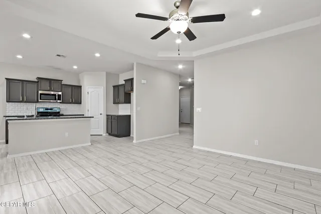 a view of kitchen with granite countertop cabinets and window