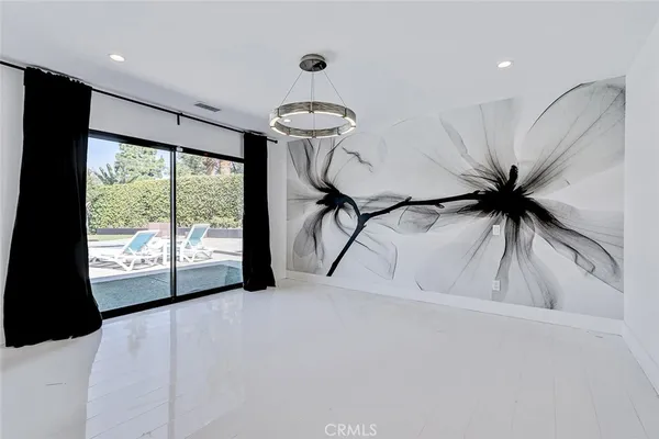 a view of a livingroom with a ceiling fan and a large window