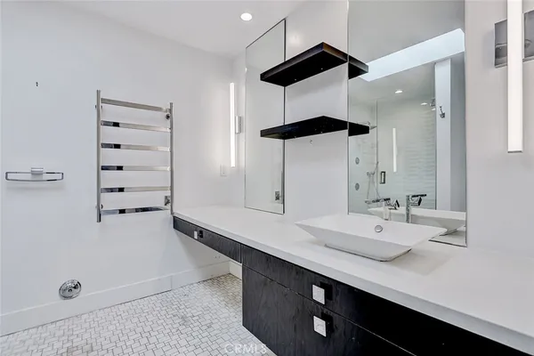 a bathroom with a double vanity sink a mirror and a shower