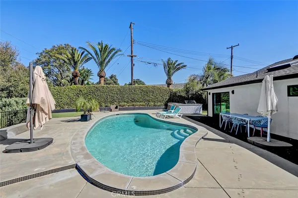 swimming pool view with a outdoor seating