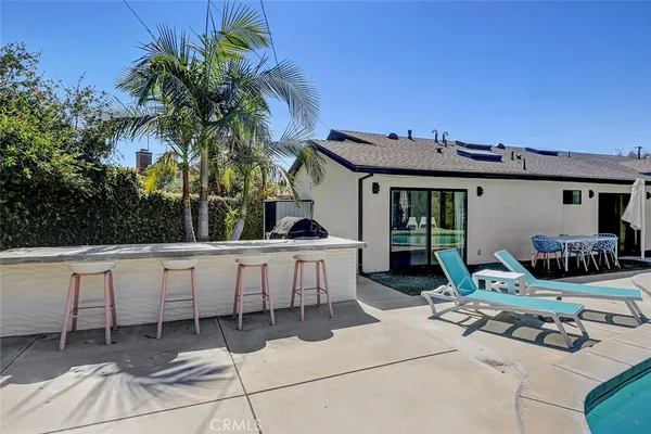 a view of a patio with table and chairs a barbeque with wooden fence