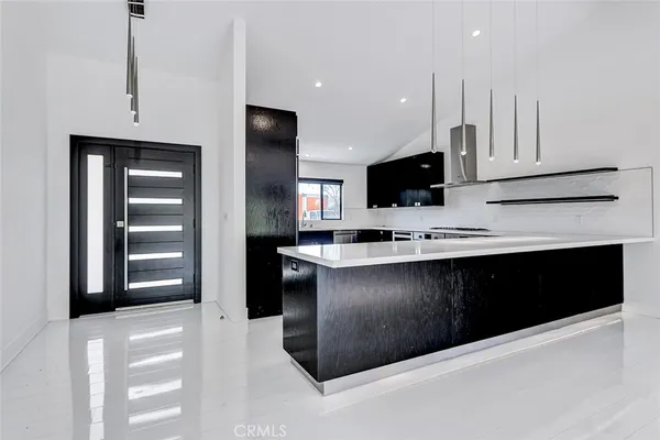 a kitchen with stainless steel appliances kitchen island granite countertop a refrigerator oven a sink and dishwasher
