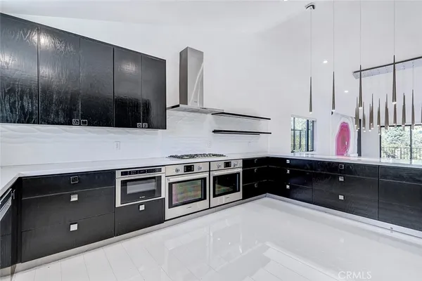 a kitchen with stainless steel appliances kitchen island granite countertop a refrigerator and a stove