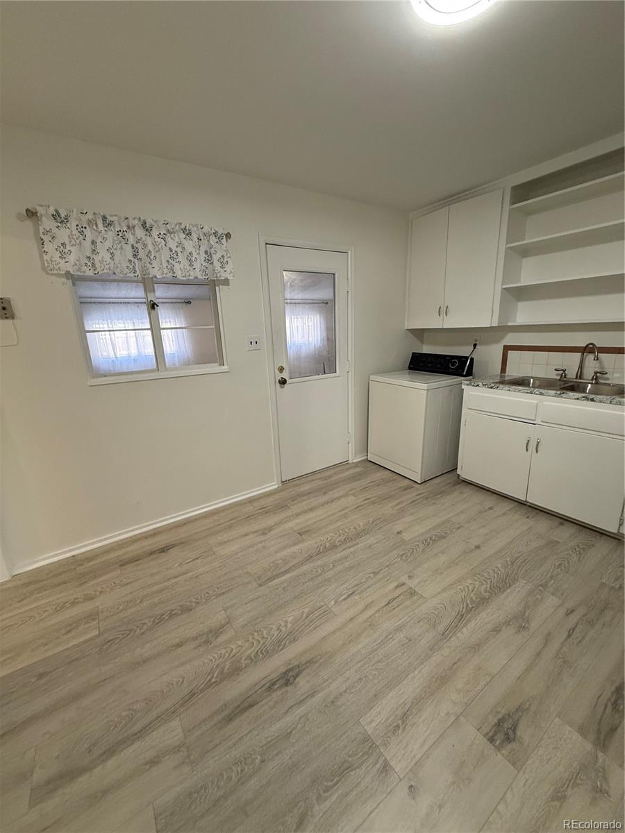 756 Vaughn Street Aurora, CO 80011 - Photo 11 of 22 a view of a kitchen with a sink dishwasher and a microwave oven
