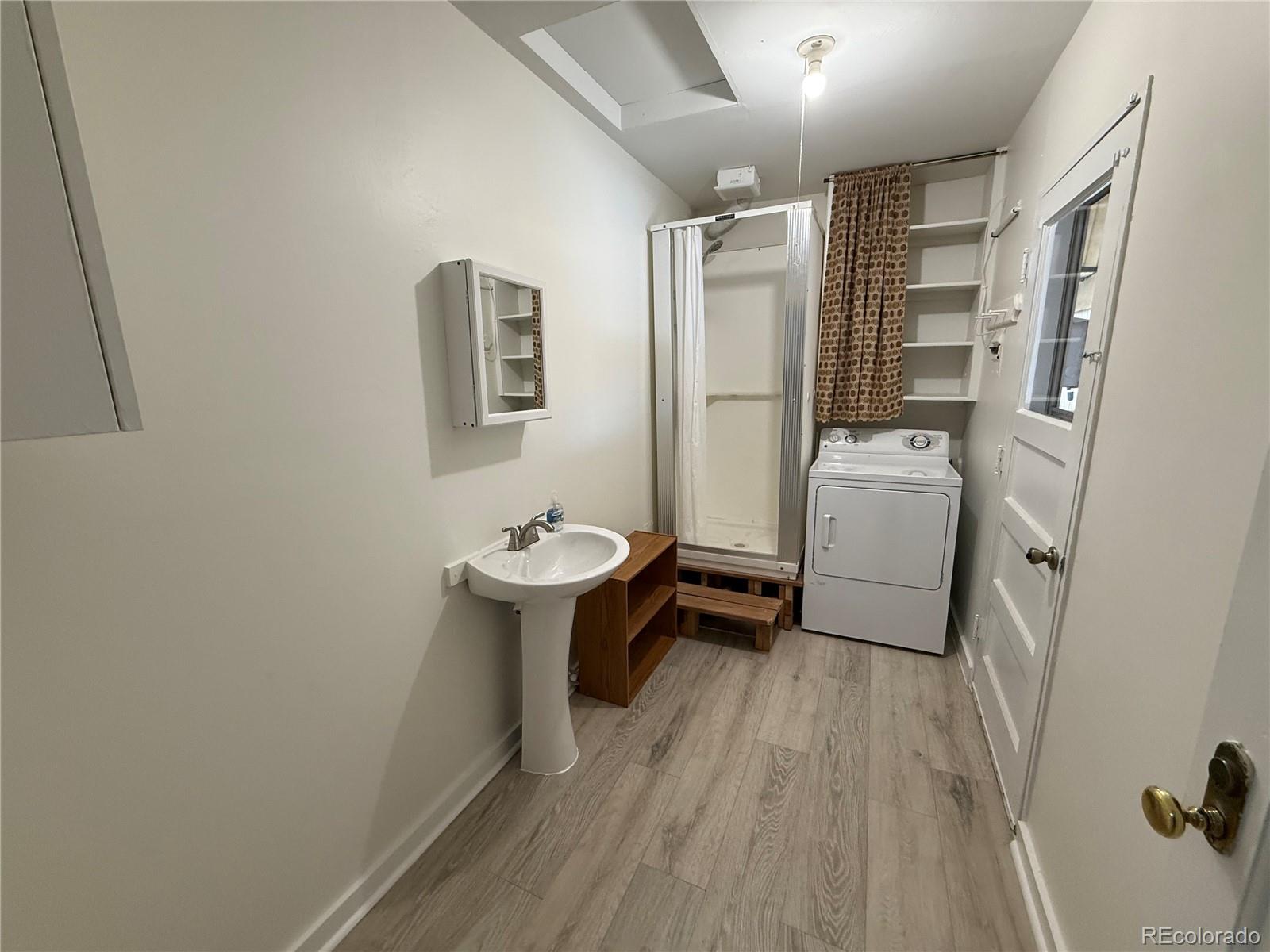 756 Vaughn Street Aurora, CO 80011 - Photo 12 of 22 a bathroom with a sink toilet and shower
