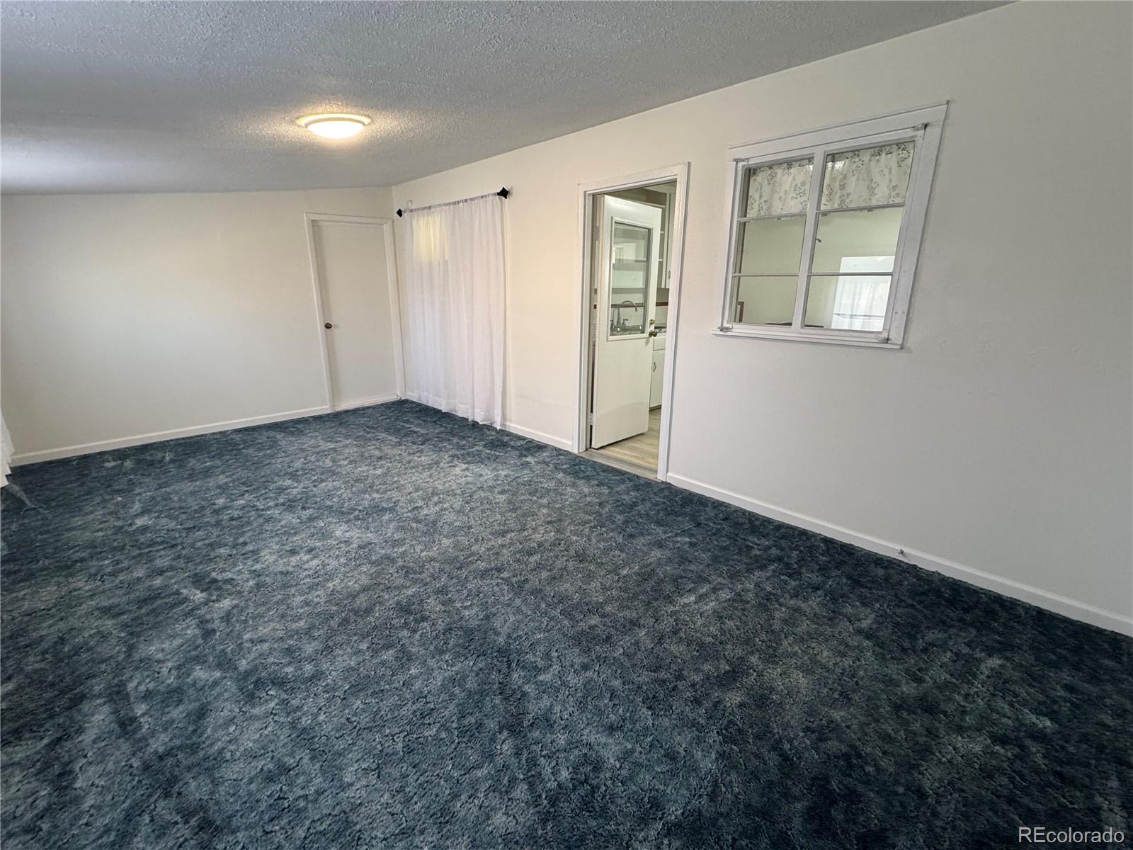 756 Vaughn Street Aurora, CO 80011 - Photo 14 of 22 an empty room with windows