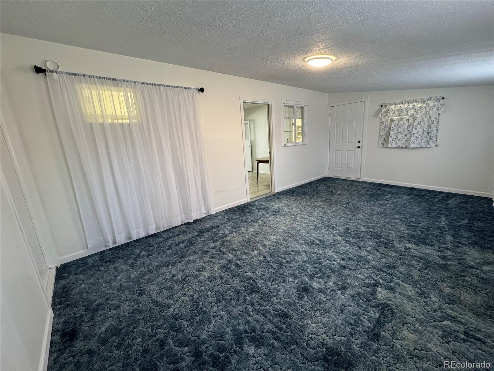 756 Vaughn Street Aurora, CO 80011 - Photo 15 of 22 an empty room with windows