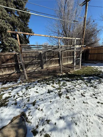 a view of a backyard with wooden fence