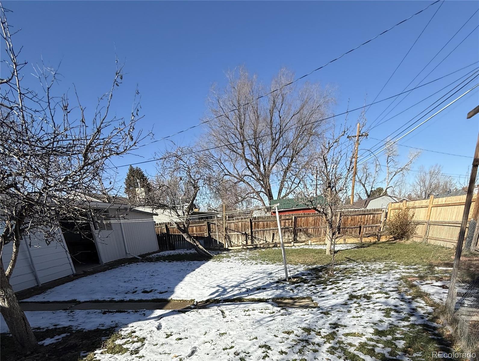 756 Vaughn Street Aurora, CO 80011 - Photo 20 of 22 a view of a backyard with wooden fence