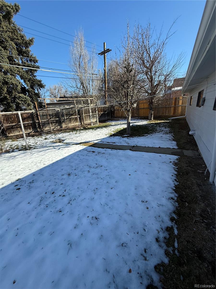 756 Vaughn Street Aurora, CO 80011 - Photo 21 of 22 a view of a backyard with chairs