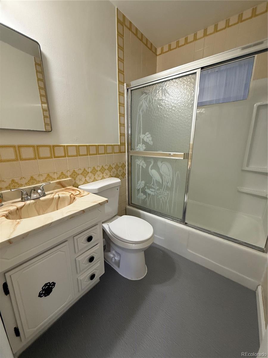 756 Vaughn Street Aurora, CO 80011 - Photo 7 of 22 a bathroom with a sink a toilet and shower