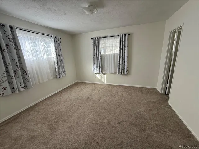 a kitchen with a refrigerator a stove top oven a sink and dishwasher with wooden floor