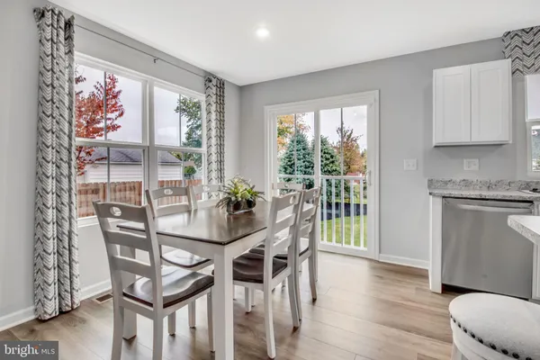 a dining room with furniture and wooden floor