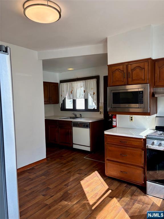 28 Arlington Avenue Paterson, NJ 07502 - Photo 11 of 25 a kitchen with stainless steel appliances granite countertop a stove and a microwave