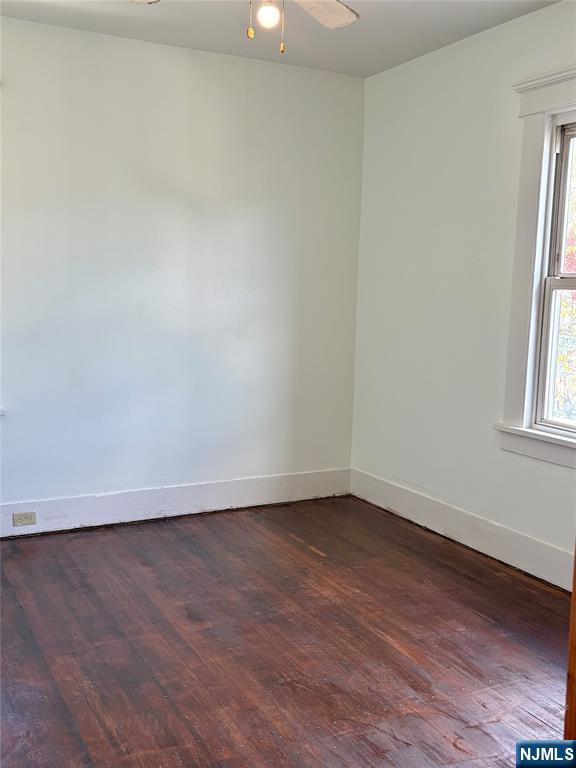 28 Arlington Avenue Paterson, NJ 07502 - Photo 19 of 25 an empty room with wooden floor and windows