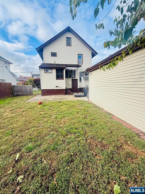 28 Arlington Avenue Paterson, NJ 07502 - Photo 6 of 25 a front view of a house with a yard