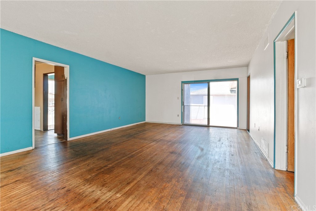 8849 Pico Vista Road Pico Rivera, CA 90660 - Photo 5 of 35 a view of an empty room with wooden floor and a window
