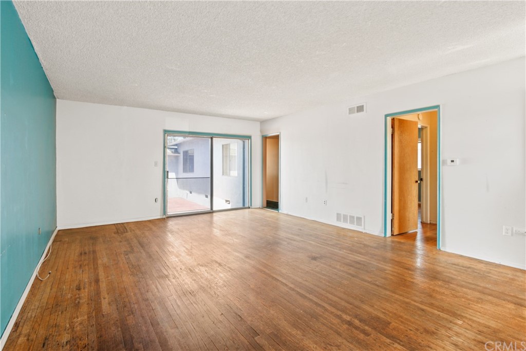 8849 Pico Vista Road Pico Rivera, CA 90660 - Photo 6 of 35 a view of an empty room with wooden floor and a window