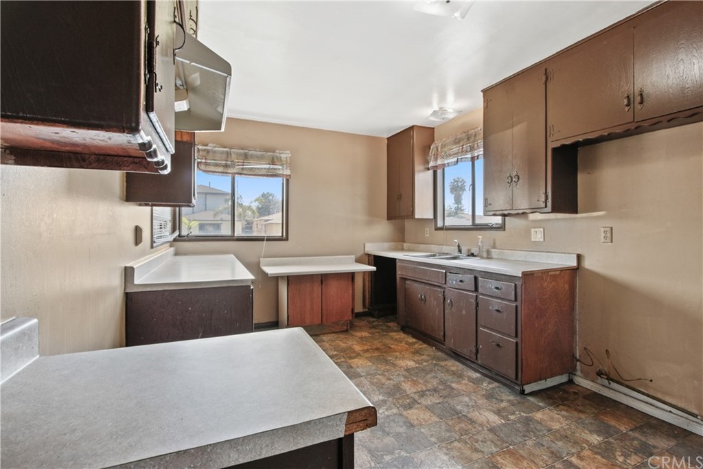 8849 Pico Vista Road Pico Rivera, CA 90660 - Photo 10 of 35 a kitchen with a sink stove and wooden cabinets