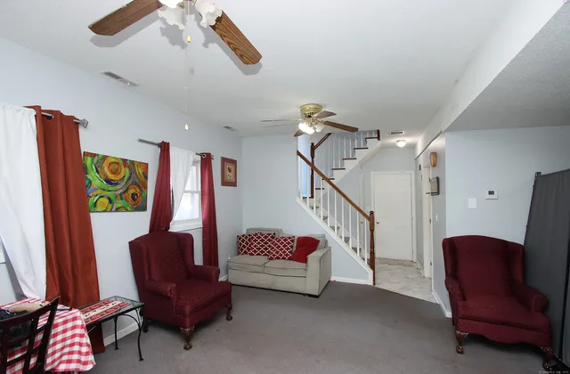 a living room with furniture and a chair
