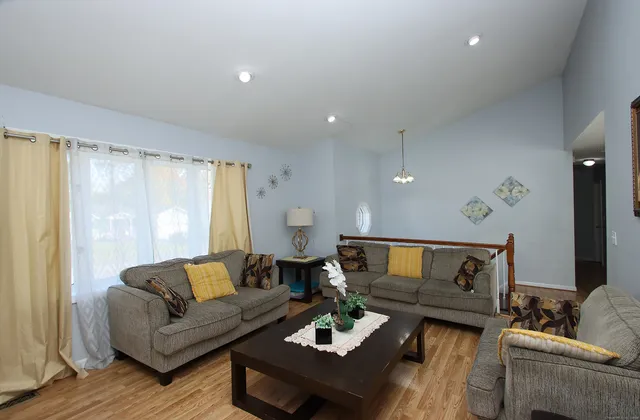 a living room with furniture and a large window