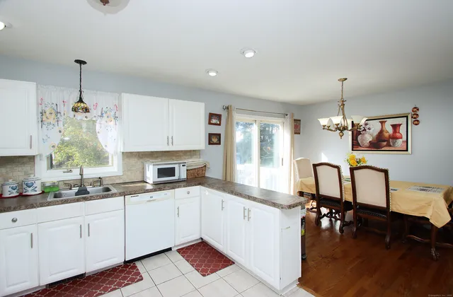 a kitchen with a sink cabinets and window