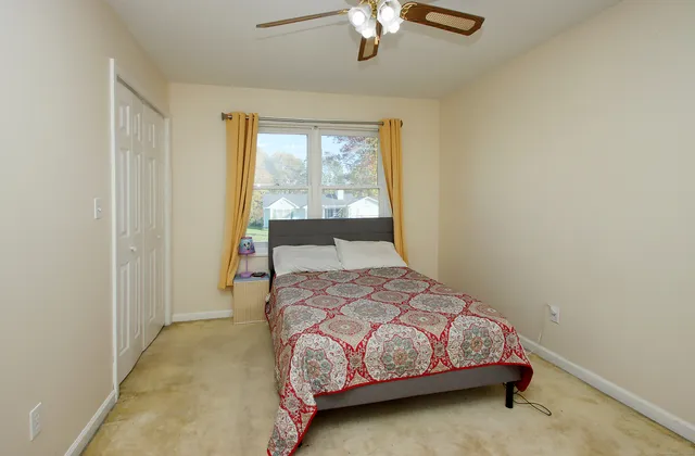 a bedroom with a bed and window