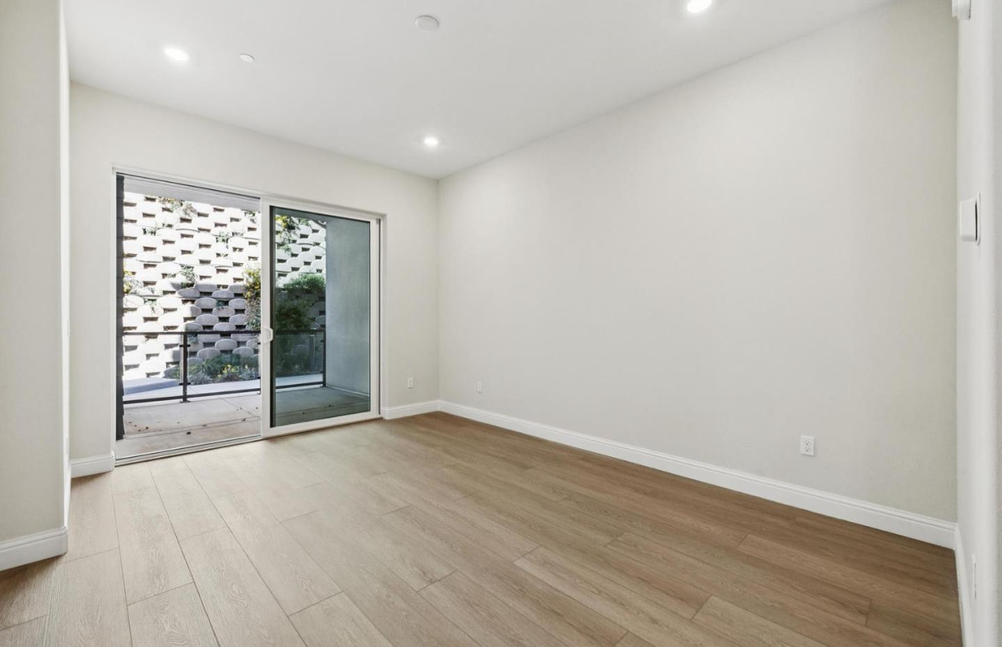 2425 Willow Way San Mateo, CA 94403 - Photo 14 of 39 an empty room with wooden floor and windows