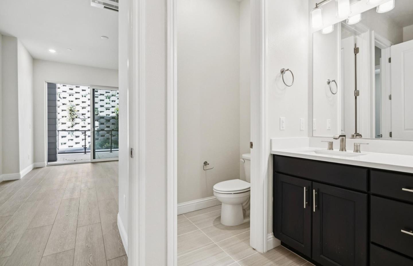 2425 Willow Way San Mateo, CA 94403 - Photo 19 of 39 a spacious bathroom with a toilet sink double vanity and mirror
