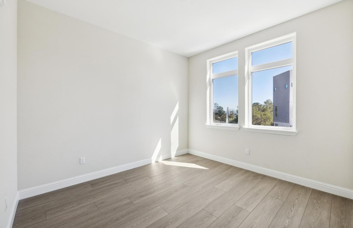 2425 Willow Way San Mateo, CA 94403 - Photo 26 of 39 an empty room with wooden floor and windows