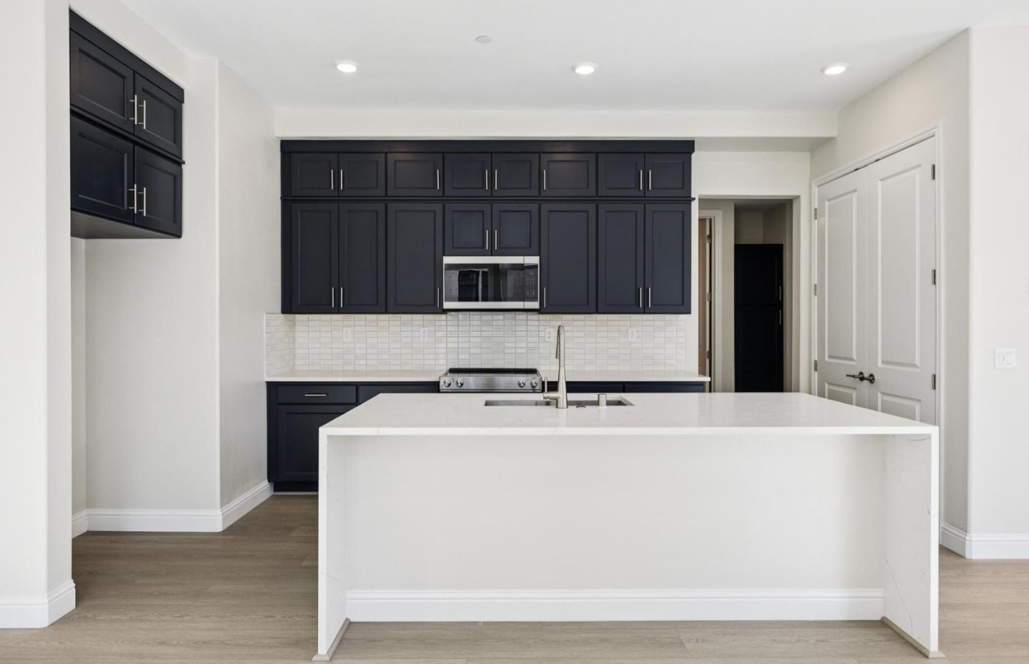 2425 Willow Way San Mateo, CA 94403 - Photo 4 of 39 a utility room with stainless steel appliances wooden cabinets and a refrigerator