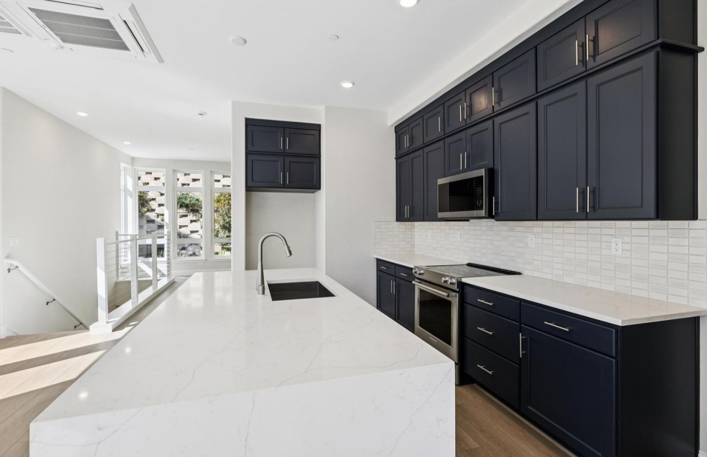 2425 Willow Way San Mateo, CA 94403 - Photo 6 of 39 a kitchen with stainless steel appliances a stove microwave and sink