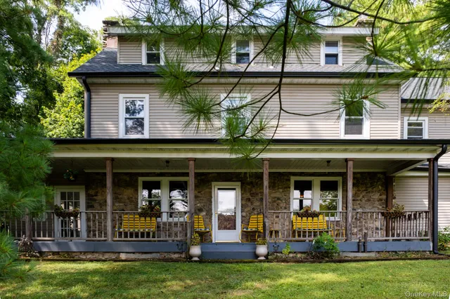 a view of a cafe with a fountain and a large tree