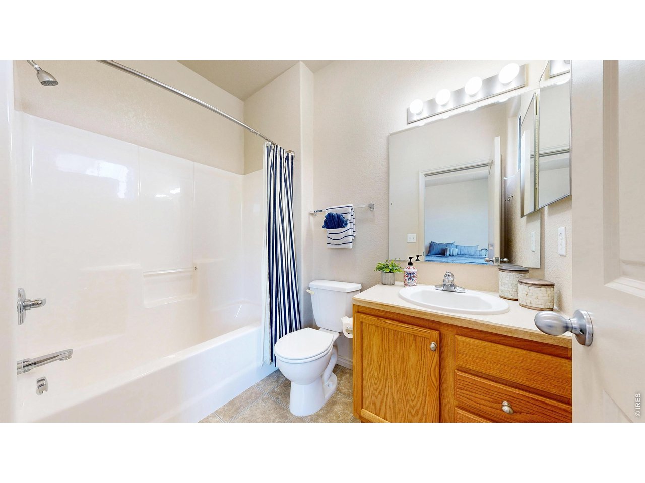 4672 West 20th Road, Unit 413 Greeley, CO 80634 - Photo 27 of 37 a bathroom with a sink toilet a mirror and bathtub