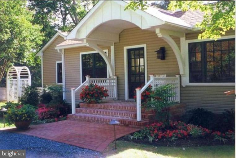 6857 Edge Creek Road St. Michaels, MD 21663 - Photo 1 of 13 a front view of a house with a yard
