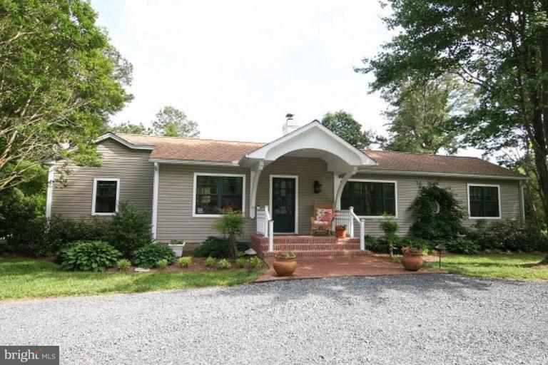 6857 Edge Creek Road St. Michaels, MD 21663 - Photo 2 of 13 a front view of house with yard and green space