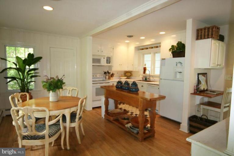 6857 Edge Creek Road St. Michaels, MD 21663 - Photo 8 of 13 a dining room with furniture and wooden floor